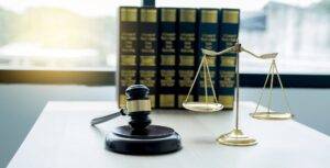 Gavel hammer, justice scale, and law textbook on table in lawyer office for providing legal consult